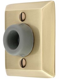 Wall-Mount Door Stop with Quincy Rosette and Rubber Bumper in Antique Brass.